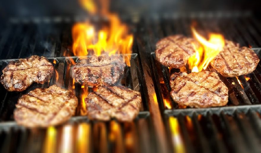 Steaks on grill with flames